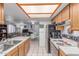 Cozy kitchen features tiled floors, wooden cabinets, and an open layout leading into the living space at 2020 W Union Hills Dr # 156, Phoenix, AZ 85027