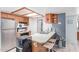 Well-lit kitchen with stainless steel appliances, oak cabinets, and a breakfast bar at 2020 W Union Hills Dr # 156, Phoenix, AZ 85027