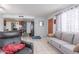 Comfortable living room featuring tile flooring, gray sofa, and adjacent kitchen area at 2020 W Union Hills Dr # 156, Phoenix, AZ 85027