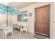 Cozy outdoor patio with table, chairs, bench, umbrella, and secure screen door at 2020 W Union Hills Dr # 156, Phoenix, AZ 85027