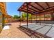 Large backyard with gravel, multiple pergolas, privacy wall, and potential for landscaping at 2109 E Gelding Dr, Phoenix, AZ 85022