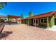 Beautiful backyard with a rock landscape, patio, pergola, and a lush green exterior, ideal for relaxation and entertaining at 2109 E Gelding Dr, Phoenix, AZ 85022