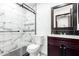 This remodeled bathroom has a tiled shower, glass doors, a new vanity and updated fixtures at 2109 E Gelding Dr, Phoenix, AZ 85022