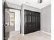 This bedroom features neutral-colored walls, carpet flooring, and a black closet with sliding doors at 2109 E Gelding Dr, Phoenix, AZ 85022