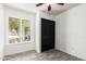 Bright bedroom with wood-look flooring, closet, and natural light from a window overlooking a lovely yard at 2109 E Gelding Dr, Phoenix, AZ 85022