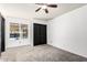 Carpeted bedroom featuring a window and a double-door closet for ample storage at 2109 E Gelding Dr, Phoenix, AZ 85022