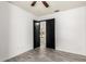 This bedroom features plank flooring, neutral-colored walls, and a black closet with sliding doors at 2109 E Gelding Dr, Phoenix, AZ 85022