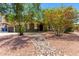 Charming home exterior with flowering trees and well-manicured desert landscaping at 2109 E Gelding Dr, Phoenix, AZ 85022