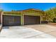 Attractive curb appeal featuring a three car garage, green home, and well-maintained landscaping at 2109 E Gelding Dr, Phoenix, AZ 85022