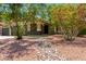 Charming home exterior with flowering trees and well-manicured desert landscaping at 2109 E Gelding Dr, Phoenix, AZ 85022