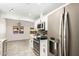 Spacious kitchen featuring stainless steel appliances, white cabinetry, and tile flooring at 2109 E Gelding Dr, Phoenix, AZ 85022