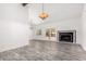 Spacious living room with wood-look flooring, fireplace, beamed ceiling, and sliding door access to the patio at 2109 E Gelding Dr, Phoenix, AZ 85022