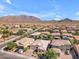 An aerial view of a single Gathering home surrounded by desert landscaping and mountain views at 2459 E Lindrick Dr, Gilbert, AZ 85298