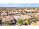 An aerial view showcases a desert community with lush greenery and a tranquil pool at 2459 E Lindrick Dr, Gilbert, AZ 85298