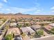 An aerial view of a single Gathering home surrounded by desert landscaping and mountain views at 2459 E Lindrick Dr, Gilbert, AZ 85298