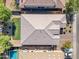 A bird's eye view reveals a well-maintained tile roof, backyard lawn, and refreshing pool at 2459 E Lindrick Dr, Gilbert, AZ 85298
