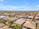 An aerial view showcases a desert community with lush greenery and a tranquil pool at 2459 E Lindrick Dr, Gilbert, AZ 85298