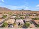 An aerial view of a single Gathering home surrounded by desert landscaping and mountain views at 2459 E Lindrick Dr, Gilbert, AZ 85298
