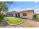 Spacious backyard with artificial turf and a covered patio perfect for gatherings and relaxation at 2459 E Lindrick Dr, Gilbert, AZ 85298