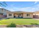 Picturesque backyard featuring artificial turf, covered patio, and gravel, ideal for outdoor living at 2459 E Lindrick Dr, Gilbert, AZ 85298
