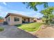 Expansive backyard with artificial turf, covered patio, and gravel landscaping creating a peaceful outdoor retreat at 2459 E Lindrick Dr, Gilbert, AZ 85298