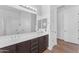Bright bathroom featuring a double sink vanity with dark cabinets and sleek fixtures at 2459 E Lindrick Dr, Gilbert, AZ 85298