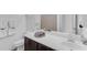 Bathroom featuring a white sink, brown cabinets, a mirror and a decorative tray on the counter at 2459 E Lindrick Dr, Gilbert, AZ 85298
