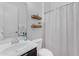 Clean bathroom featuring white fixtures, wood shelves, and decorative accents at 2459 E Lindrick Dr, Gilbert, AZ 85298