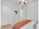 Well-lit bedroom features a ceiling fan and dresser, offering storage and comfort at 2459 E Lindrick Dr, Gilbert, AZ 85298