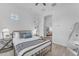 Comfortable bedroom with neutral colors, and wood-look flooring, offering soft lighting and a cozy atmosphere at 2459 E Lindrick Dr, Gilbert, AZ 85298