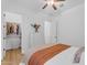 This bedroom has a ceiling fan, walk-in closet, and dresser, combining functionality and style at 2459 E Lindrick Dr, Gilbert, AZ 85298