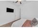 Modern bedroom with a ceiling fan and TV, offering comfort and entertainment at 2459 E Lindrick Dr, Gilbert, AZ 85298
