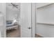 Bedroom adjacent to an empty closet with a view of a well-lit bed and a cozy room at 2459 E Lindrick Dr, Gilbert, AZ 85298