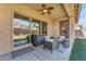 Inviting covered patio with ceiling fan and comfortable seating area for outdoor relaxation and entertainment at 2459 E Lindrick Dr, Gilbert, AZ 85298
