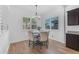 Bright dining area with wood floors, modern chandelier and windows with shutters for a cozy meal at 2459 E Lindrick Dr, Gilbert, AZ 85298