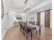 Elegant dining room featuring wood floors, stylish light fixture, and sliding barn doors for rustic charm at 2459 E Lindrick Dr, Gilbert, AZ 85298