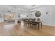 Elegant dining area featuring an ornate chandelier, hardwood floors, and an open-concept layout at 2459 E Lindrick Dr, Gilbert, AZ 85298