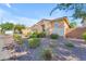 Charming single-story home featuring low-maintenance desert landscaping and neutral tones under a clear blue sky at 2459 E Lindrick Dr, Gilbert, AZ 85298