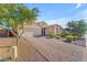 Charming home with a paver driveway, well-manicured landscaping, and a two-car garage on a sunny day at 2459 E Lindrick Dr, Gilbert, AZ 85298