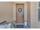 Charming front porch with a decorative wreath, cozy seating, potted flowers, and a welcoming entrance at 2459 E Lindrick Dr, Gilbert, AZ 85298