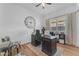 Home office with natural light, a dark wood desk, a modern clock and built-in bookshelves at 2459 E Lindrick Dr, Gilbert, AZ 85298