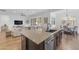 Open-concept kitchen featuring a breakfast bar, stainless steel appliances, and seamless flow to the living area at 2459 E Lindrick Dr, Gilbert, AZ 85298