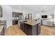 Well-appointed kitchen with dark cabinetry, stainless steel appliances, and a breakfast bar at 2459 E Lindrick Dr, Gilbert, AZ 85298