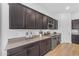 Lovely kitchen boasting dark cabinets, granite countertops, and stainless steel appliances at 2459 E Lindrick Dr, Gilbert, AZ 85298