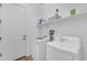 Well-organized laundry room with white appliances, shelving, and ample storage space and a clean interior at 2459 E Lindrick Dr, Gilbert, AZ 85298