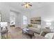 Bright living room with hardwood floors, neutral furniture, and a tranquil atmosphere perfect for relaxation at 2459 E Lindrick Dr, Gilbert, AZ 85298