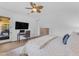 Bright main bedroom with wood floors, ceiling fan, and convenient home office setup at 2459 E Lindrick Dr, Gilbert, AZ 85298