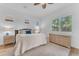 Bright main bedroom with natural light, plush bedding, and wood floors at 2459 E Lindrick Dr, Gilbert, AZ 85298