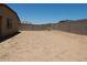 Large, empty backyard with block wall, perfect for customization and outdoor activities at 25744 W Winston Dr, Buckeye, AZ 85326