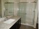 Bathroom includes a large vanity top, a glass door shower stall, and linen closet at 25744 W Winston Dr, Buckeye, AZ 85326